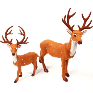 Lifelike Christmas reindeer figurines with brown flocked texture for holiday window displays
