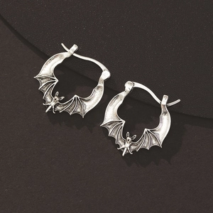 Detailed view of gothic vampire bat earrings with vintage silver wing texture and metallic finish