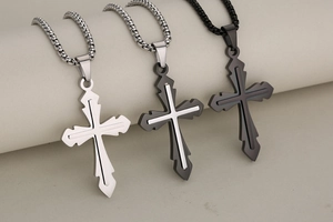 Detailed view of stainless steel cross pendants in silver and black on box chains