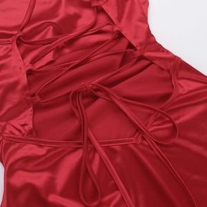 Detail of red satin evening gown featuring sexy criss-cross tie-back straps design