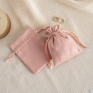 Detailed close-up of velvet jewelry drawstring pouches in elegant lotus pink color