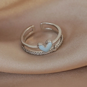 Detail of silver adjustable ring with light blue heart enamel and sparkling zircon pavé