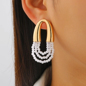 Close-up of French vintage multi-layer pearl tassel earrings on a model ear