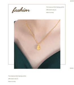 Detail shot of a golden teardrop pendant with starburst zircon on a dainty chain