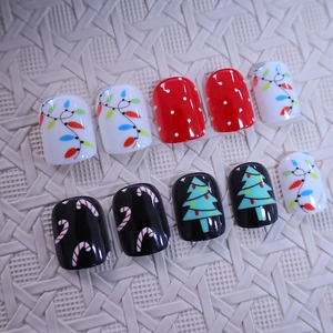 Short press-on nails with Christmas trees, colorful lights and candy cane patterns