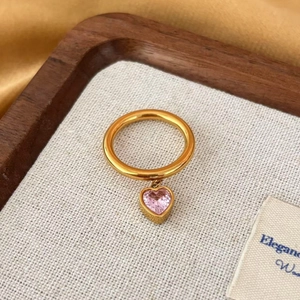 Gold stainless steel ring featuring a dangling pink heart-shaped zircon pendant