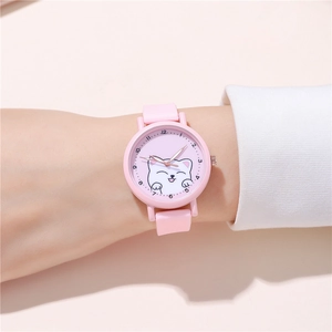 Detail of pink silicone watch band and dial featuring a white kitten cartoon pattern