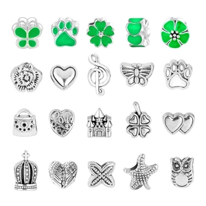 Macro shot of 20 silver-style DIY charms with green enamel and assorted animal shapes