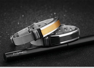Macro shot of stainless steel mesh bracelets in gold and black with Milanese weave detail