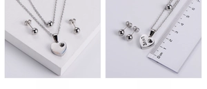 Macro view of love heart pendant necklace and round bead earrings set with size measurement