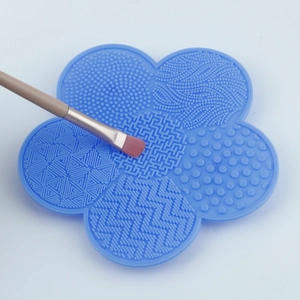 Sky blue flower-shaped silicone makeup brush cleaning pad with various textures