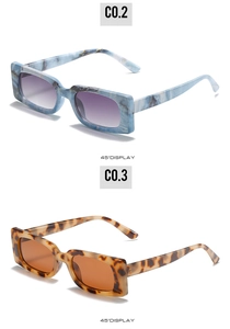 Detail view of rectangular sunglasses in blue marble and tortoise patterns with gradient lenses