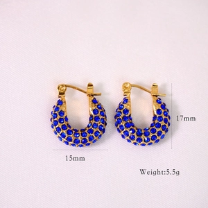 Detailed view of gold U-shaped earrings with blue crystals and size measurements