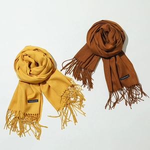 Soft cashmere solid fringe scarves in warm yellow and brown tones for winter warmth