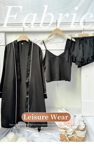 Detailed close-up of 3-piece black satin sleepwear set with pink piping and silk texture