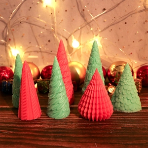 Detailed view of pink and mint green Christmas tree candles with unique textures
