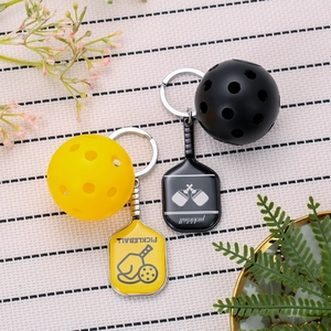 Pickleball paddle keychain set in yellow and black zinc alloy with hollow balls