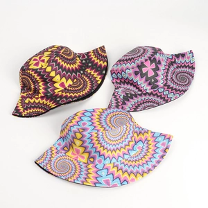 Detailed top view of three reversible bucket hats with vibrant tie-dye psychedelic patterns
