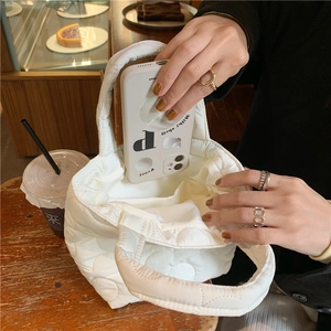 Quilted mini handbag for women showing interior space for smartphone and snacks