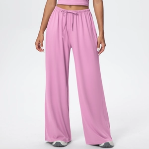Detail of high waist elastic waistband with drawstring on pink wide-leg sports trousers