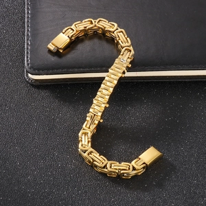Macro detail of golden Byzantine chain bracelet with polished rectangular clasp closure