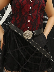 Close-up of a punk style leather belt with metal rose buckle and silver rivets detail