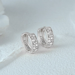 Macro shot of 925 sterling silver hoop earrings with small cubic zirconia and S925 hallmark
