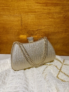 Elegant gold glitter evening clutch bag with rhinestone clasp and metal chain strap