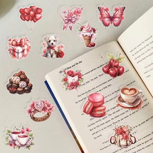 Romantic cartoon gift stickers scattered on an open book for DIY diary and luggage decoration