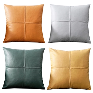 Modern square faux leather throw pillows in orange, gray, green, and yellow with cross stitching