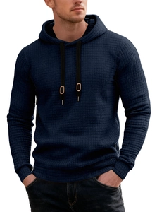 Detailed close-up of dark blue waffle knit texture and black hood drawstring with metal tips