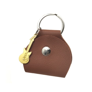 Brown leather guitar pick pouch with metallic snap and small electric guitar pendant