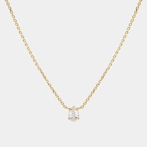 Close-up of golden teardrop zircon pendant necklace with three-prong setting detail