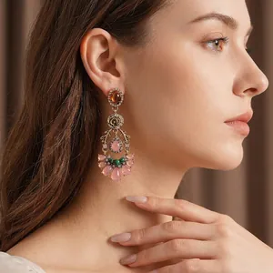 Vintage gold earrings with crystal flowers and water drop stones on a female model