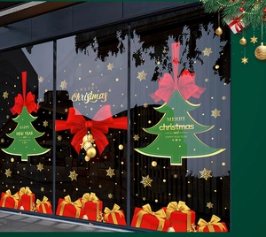 Detailed Christmas window decals featuring festive trees, red bows, and gift boxes on glass