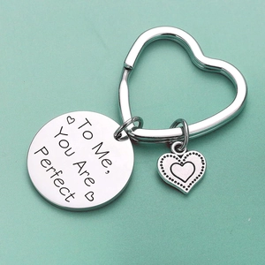 Detailed view of silver heart keychain with engraved To Me You Are Perfect message