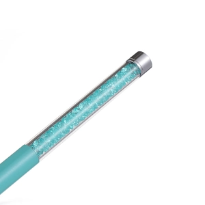 Macro detail of lake blue crystal rhinestones inside a transparent acrylic pen barrel