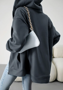 Rear view of a loose fit dark grey hooded cardigan with a blue crocodile pattern chain bag