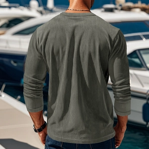 Back view of a men's olive green long sleeve ribbed knit T-shirt in an outdoor setting