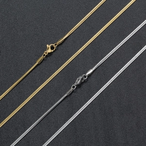 Detailed view of 2mm gold and silver stainless steel flat snake chain necklaces with clasps