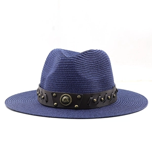 Detailed macro of dark blue woven straw fedora hat featuring studded leather band