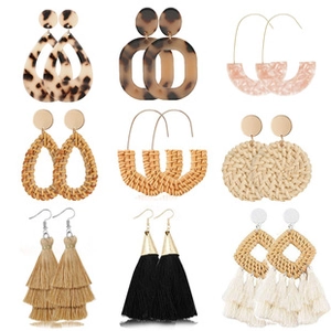 Collection of nine bohemian style earrings with resin, rattan, and tassel details