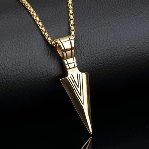 Men's vintage golden arrow pendant necklace with box chain on textured black background