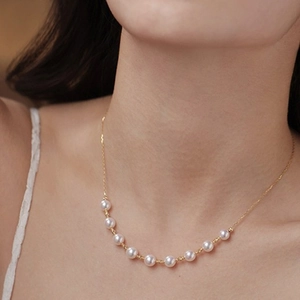 Elegant natural freshwater pearl gold plated necklace worn by a model on neck