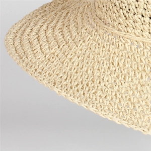 Dettaglio macro della trama intrecciata in paglia naturale del cappello da sole