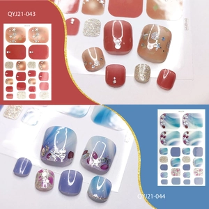 Close-up of waterproof toe nail wraps with starfish design and sparkling rhinestones