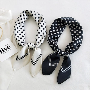 Polka dot satin silk square scarf set in black and white displayed with a white shirt
