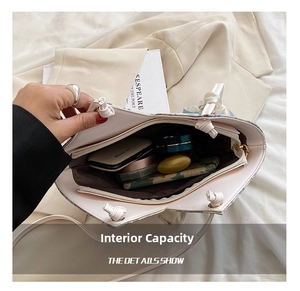 Detail view of large interior capacity of a canvas tote bag with silk scarf and cosmetics