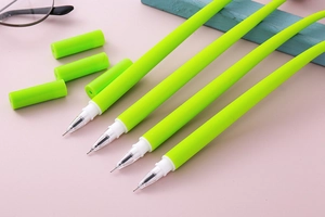 Detail shot of four fluorescent green gel pens with fine needle tips on a pink desk