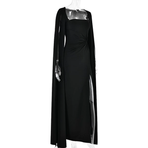 Detail view of black floor-length dress featuring a stylish cape and high side slit design